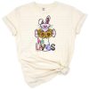 Watercolor illustration of a cross with bunny ears and Easter flowers.