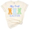 Three colorful bunnies in blue, orange, and green with festive Easter accents.