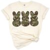 Three bunnies in army camouflage lined up in a playful Easter design.