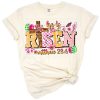 A decorative Christian cross with the phrase He Is Risen in pastel Easter colors and floral accents.