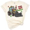 Santa Claus driving a backhoe loader in a western Christmas scene.