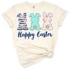 Three pastel bunnies surrounded by navy, blush, and pale teal florals in a spring-themed arrangement.
