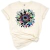 A colorful tie dye sunflower with cow print spots and floral accents in a boho retro style.
