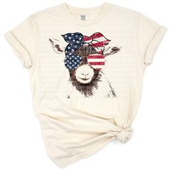 A goat wearing patriotic accessories with the USA flag background in a festive Fourth of July theme.