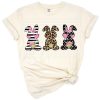Three bunnies with dark pink floral, leopard cheetah, and striped polka dot patterns.
