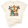 A cross embellished with pumpkins, sunflowers, and leopard print arranged in a fall-inspired composition.