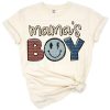 A playful design featuring the phrase Mama's Boy with cute baby boy accents and childlike charm.