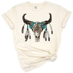 A boho-style bull skull decorated with aztec patterns and gemstones in a western-inspired design.
