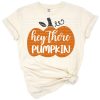 A cute orange pumpkin with autumn leaves and cheerful text in a playful style.