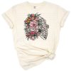 A flower-adorned skull with butterflies and a motivational message in a retro boho style.