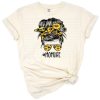 A stylish mom with messy bun, sunflower hairband, and sunglasses in a playful floral design.