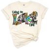A colorful retro tie dye western themed design with the phrase Living On Lake Time.