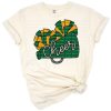 A vibrant cheerleader design in green, yellow, and gold with pom poms and stylized accents.