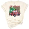 A classic red truck with a Christmas tree in a winter country scene.