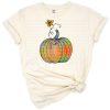 A bright orange hand drawn watercolor pumpkin with colorful painted accents in a whimsical style.