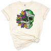 A skeleton surrounded by botanical floral accents in a grunge art style.