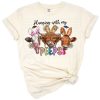 Three colorful cows wearing Easter accessories and surrounded by pastel spring accents.