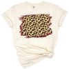 A distressed leopard animal print with red buffalo plaid splash background design.