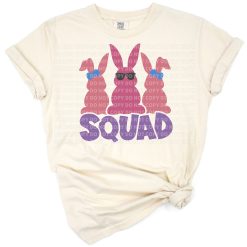 A group of playful bunnies wearing sunglasses and holding decorated Easter eggs in a cheerful spring scene.