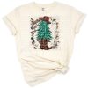 Festive Christmas trees with cowhide and cheetah patterns alongside a western Santa.