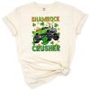 A playful monster truck surrounded by green shamrocks in a festive St. Patrick's Day theme.