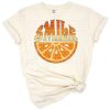A retro vintage style orange slice smiling with a cheerful face.