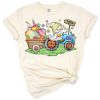 A festive spring scene with a colorful tractor, cheerful gnome, and a cute rabbit surrounded by Easter decorations.