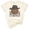 A group of pumpkins with a cowboy hat in a rustic western fall style.